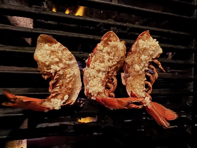 Lobster tails with garlic butter cooking over open flame at Rocklobster Fest, Josabi's, Helotes, Texas
